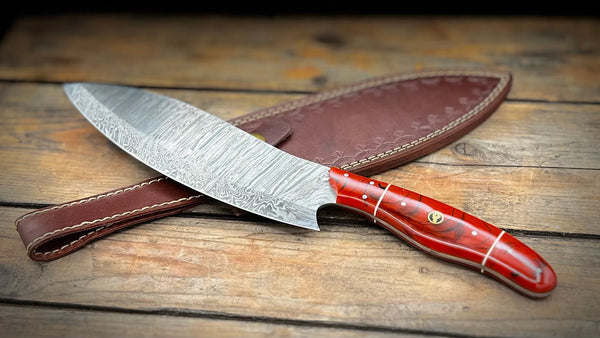 A BigHorn Steel Damascus knife with a red handle and a leather sheath