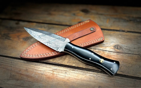 A BigHorn Steel everday carry knife with a black handle and leather sheath